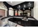 Elegant wet bar with granite countertop and dark wood cabinetry at 8515 E Sutton Dr, Scottsdale, AZ 85260