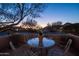 Evening view of a private patio with seating for four and a small potted plant at 9023 N Crown Ridge --, Fountain Hills, AZ 85268