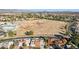 Aerial view of house near park and school with mountain backdrop at 9031 N 83Rd Way, Scottsdale, AZ 85258