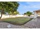 Landscaped backyard featuring a grassy area, paved pathway, and pool at 9031 N 83Rd Way, Scottsdale, AZ 85258