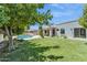 Expansive backyard showcasing a beautiful pool, lush landscaping, and outdoor living spaces at 9031 N 83Rd Way, Scottsdale, AZ 85258