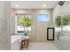 Bright bathroom with soaking tub, walk-in shower, and garden view at 9031 N 83Rd Way, Scottsdale, AZ 85258