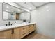 Elegant bathroom featuring a double vanity and large mirror at 9031 N 83Rd Way, Scottsdale, AZ 85258