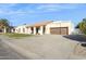 Single story home with a tile roof, brown garage door, and manicured lawn at 9031 N 83Rd Way, Scottsdale, AZ 85258