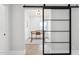 Spacious home office with a sliding barn door and wood desk at 9031 N 83Rd Way, Scottsdale, AZ 85258