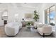 Bright living room with modern furniture, herringbone floors, and seamless flow to the kitchen at 9031 N 83Rd Way, Scottsdale, AZ 85258