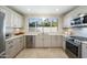 Modern kitchen featuring stainless steel appliances and light cabinetry at 9448 N 80Th Pl, Scottsdale, AZ 85258