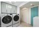 Laundry room with washer, dryer, and cabinets at 9448 N 80Th Pl, Scottsdale, AZ 85258