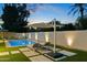 Relaxing pool area at dusk with lounge chairs and umbrella at 9448 N 80Th Pl, Scottsdale, AZ 85258