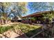 Large backyard with grassy area, mature trees, and plenty of space for recreation at 10022 N Erin Ct, Waddell, AZ 85355