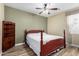 Bright bedroom featuring a double bed and wood shelving at 10022 N Erin Ct, Waddell, AZ 85355