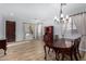 Formal dining room with hardwood floors and elegant chandelier at 10022 N Erin Ct, Waddell, AZ 85355