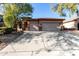 House exterior with a three-car garage and landscaped yard at 10022 N Erin Ct, Waddell, AZ 85355