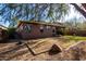 Back exterior view of the house showcasing a large grassy backyard at 10022 N Erin Ct, Waddell, AZ 85355