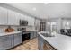 Modern kitchen with gray cabinets, white countertops, and stainless steel appliances at 10022 N Erin Ct, Waddell, AZ 85355