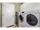 Laundry room with washer, dryer, and extra storage at 10022 N Erin Ct, Waddell, AZ 85355