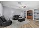 Living room with leather furniture and built-in shelving at 10022 N Erin Ct, Waddell, AZ 85355