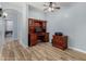 Home office with built-in wood desk and cabinets at 10022 N Erin Ct, Waddell, AZ 85355