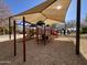 Shaded playground with play structures and swings at 10022 N Erin Ct, Waddell, AZ 85355