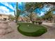 Community putting green surrounded by desert landscaping at 10222 E Southwind E Ln # 1026, Scottsdale, AZ 85262