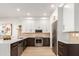 Modern kitchen with white and dark wood cabinets, quartz countertops, and stainless steel appliances at 10222 E Southwind Ln # 1026, Scottsdale, AZ 85262