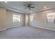 Spacious bedroom with ceiling fan and large windows at 10434 E Texas Ave, Mesa, AZ 85212