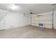 Two-car garage with overhead storage and door opener at 10434 E Texas Ave, Mesa, AZ 85212