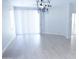 Bright dining room with hardwood floors and a modern chandelier at 10549 E Flossmoor Ave, Mesa, AZ 85208