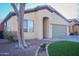 House exterior showcasing a front yard and tree at 10549 E Flossmoor Ave, Mesa, AZ 85208