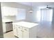 Open concept kitchen with white cabinets and an island at 10549 E Flossmoor Ave, Mesa, AZ 85208