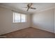 Cozy bedroom with carpet flooring and ceiling fan at 10615 N 102Nd Dr, Sun City, AZ 85351