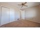 Bedroom with carpet flooring, double closet, and ceiling fan at 10615 N 102Nd Dr, Sun City, AZ 85351