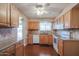 Bright kitchen with wood cabinets and granite countertops at 10615 N 102Nd Dr, Sun City, AZ 85351