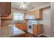 Kitchen with wood cabinets, granite counters, and appliances at 10615 N 102Nd Dr, Sun City, AZ 85351