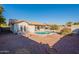 Home with a kidney-shaped pool and patio at 10811 E Contessa St, Mesa, AZ 85207