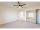 Bright bedroom with mirrored closet doors and ceiling fan at 10811 E Contessa St, Mesa, AZ 85207