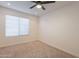 Simple bedroom with neutral carpeting and window blinds at 10811 E Contessa St, Mesa, AZ 85207