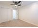 Well-lit bedroom with mirrored closet doors and ceiling fan at 10811 E Contessa St, Mesa, AZ 85207