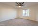 Spacious bedroom with neutral carpeting and ceiling fan at 10811 E Contessa St, Mesa, AZ 85207