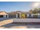 Single-story home with a brown garage door and landscaped yard at 10811 E Contessa St, Mesa, AZ 85207