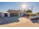 Single-story home with a brown garage door and landscaped yard at 10811 E Contessa St, Mesa, AZ 85207