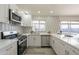 Renovated kitchen with white cabinets, quartz countertops and stylish backsplash at 10811 E Contessa St, Mesa, AZ 85207