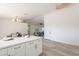 Kitchen island with white cabinets and quartz countertop, offering extra prep space at 10811 E Contessa St, Mesa, AZ 85207