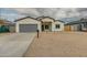 New construction home with gray garage door and neutral colors at 10869 N 81St Ave, Peoria, AZ 85345