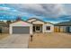 New build home with gray garage door and neutral exterior at 10869 N 81St Ave, Peoria, AZ 85345