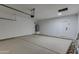 Spacious garage with overhead storage and door at 10869 N 81St Ave, Peoria, AZ 85345