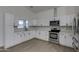 Modern kitchen with white cabinets and stainless steel appliances at 10869 N 81St Ave, Peoria, AZ 85345