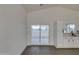 Open concept kitchen with white cabinets and sliding glass door to backyard at 10869 N 81St Ave, Peoria, AZ 85345