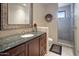 Bathroom with a walk-in shower and granite countertop vanity at 11105 E Tamarisk Way, Scottsdale, AZ 85262