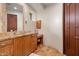 Elegant bathroom with wood cabinets and granite countertops at 11105 E Tamarisk Way, Scottsdale, AZ 85262